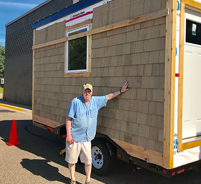 Robert Berens with a tiny house he is constructing